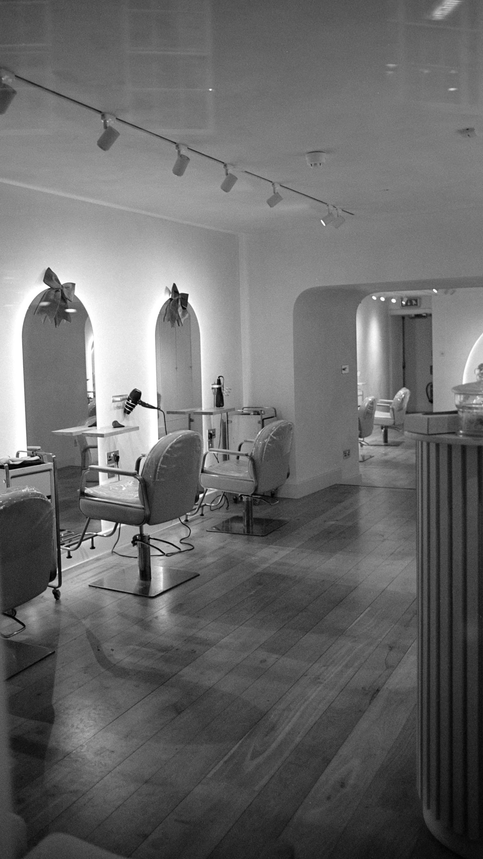 A hair salon interior with styling chairs and mirrors